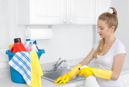 Professional carpet cleaner using safe equipment handling